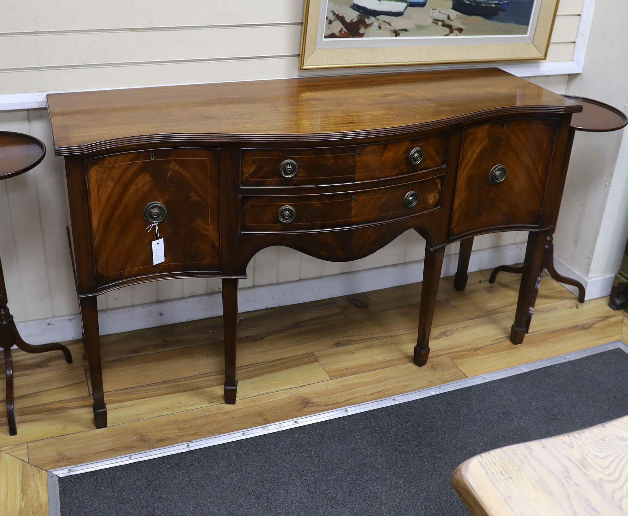 A George III style mahogany serpentine sideboard, length 152cm, depth 52cm, height 89cm